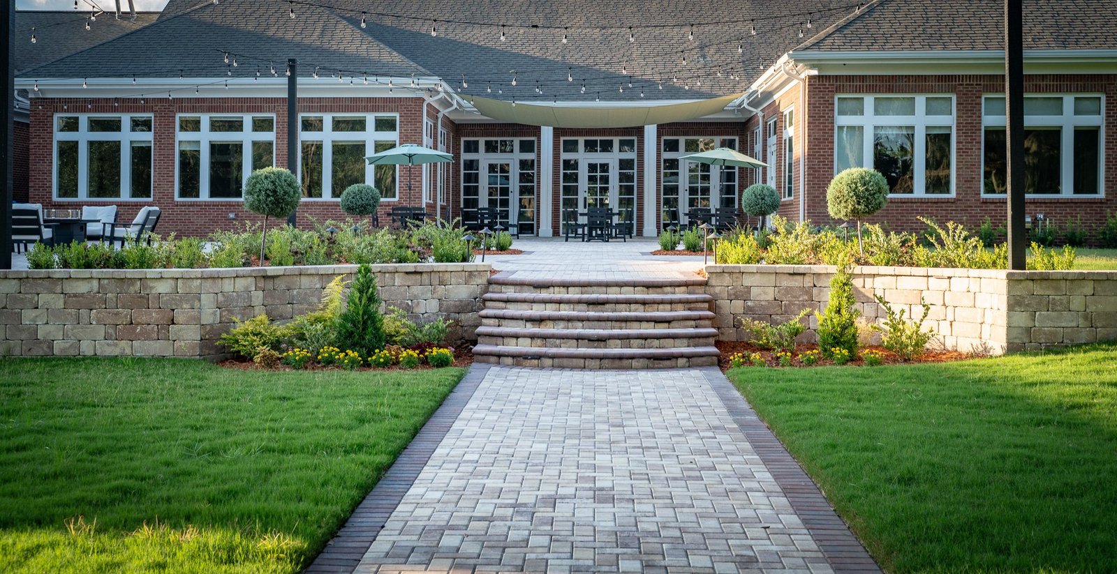 Wide view of commercial paver courtyard and outdoor seating