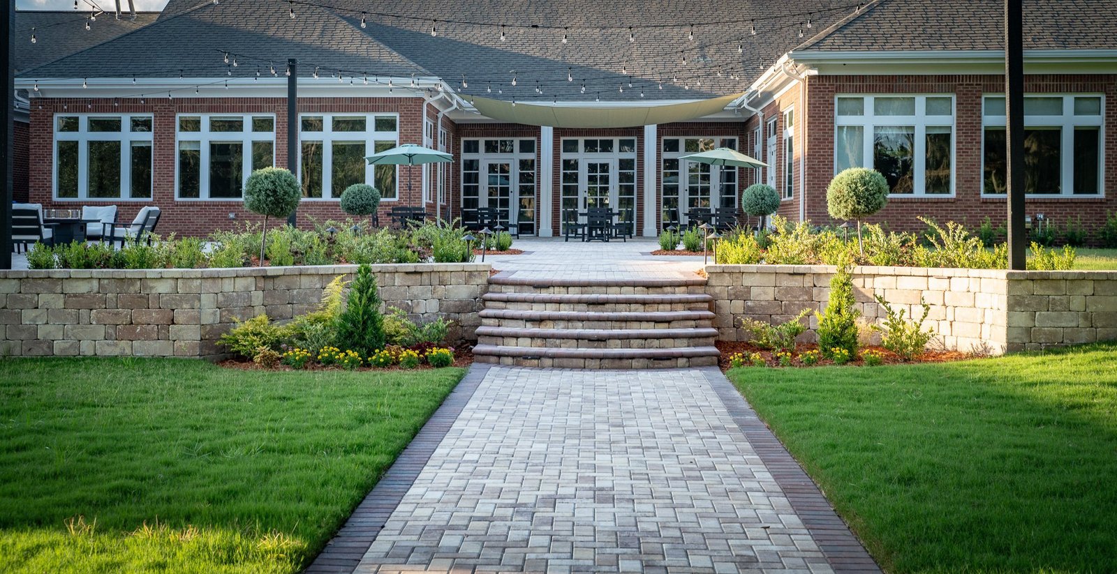 Wide-angle commercial paver entry with retaining walls